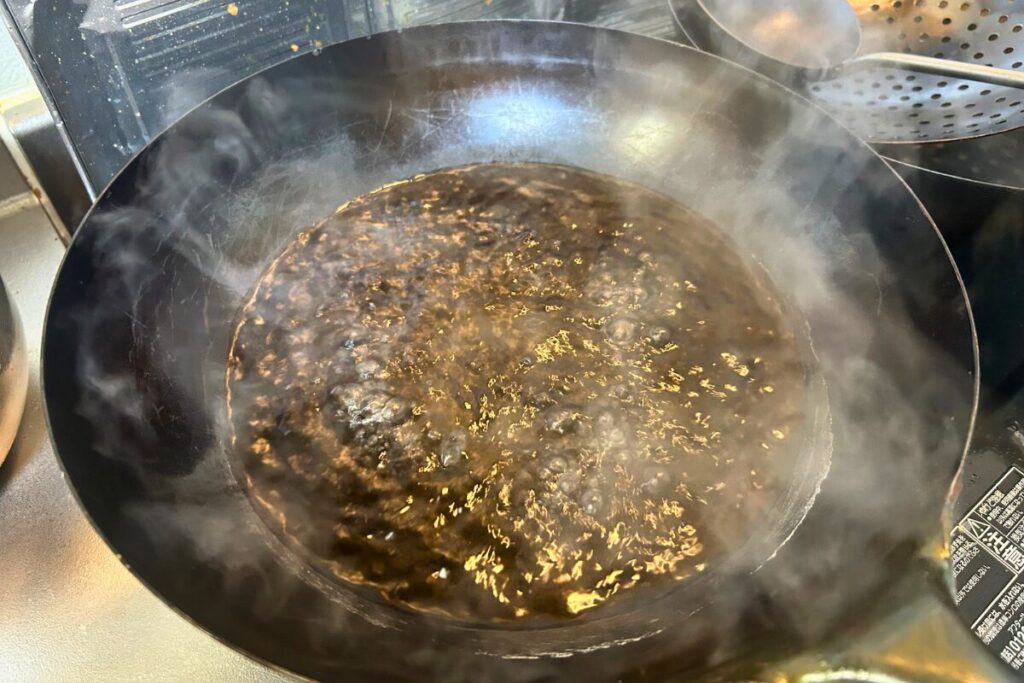 中華鍋の湯が沸騰し、白い湯気が立ちのぼっている状態